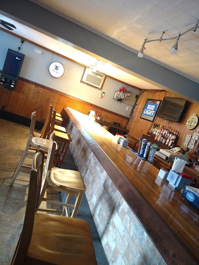 Simple dining space with bar seating nearby.